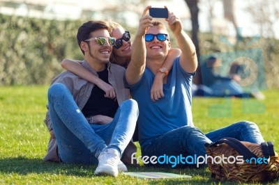 Group Of Students Taking Photos With A Smartphone In The Street Stock Photo