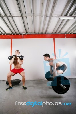 Group Of Two People Exercising Using Barbells In Gym And Kettleb… Stock Photo