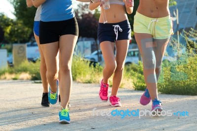 Group Of Women Running In The Park Stock Photo