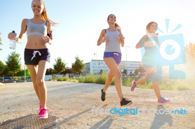 Group Of Women Running In The Park Stock Photo