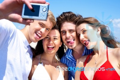 Group Of Young Friends Standing Together Taking A Self Portrait Stock Photo