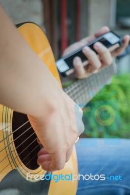 Guitarist Hand Playing Acoustic Guitar Stock Photo