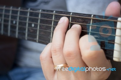 Guitarist Hand Playing Acoustic Guitar Stock Photo