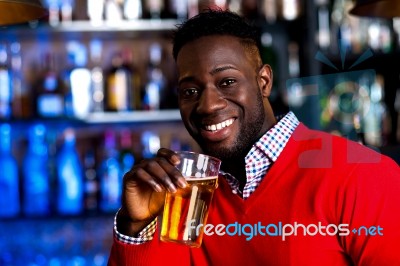 Guy Drinking Beer In A Nightclub Stock Photo