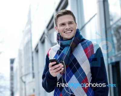 Guy Enjoying Music On Street Stock Photo