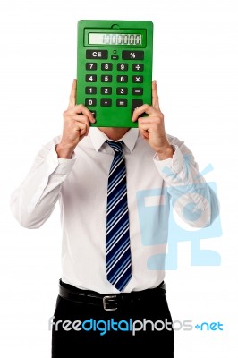 Guy Hiding His Face Behind Big Calculator Stock Photo