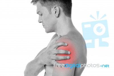 Guy Holding His Shoulder In Pain Stock Photo