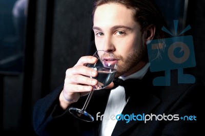 Guy In Tuxedo Drinking Cocktail Stock Photo