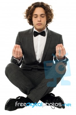 Guy In Tuxedo Striking A Lotus Posture Stock Photo