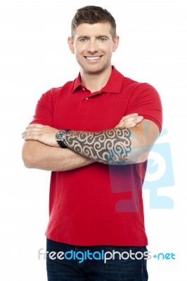 Guy Standing With Folded Arms Stock Photo