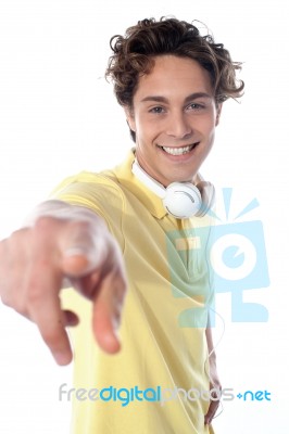 Guy With Headphones Pointing Stock Photo