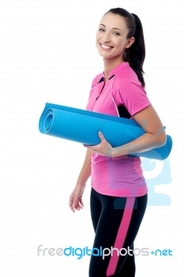 Gym Instructor Holding Blue Mat Stock Photo