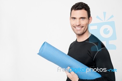 Gym Instructor Holding Mat Stock Photo