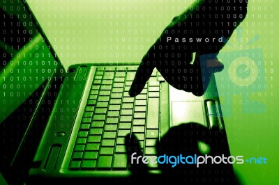 Hacker Using Laptop Stock Photo