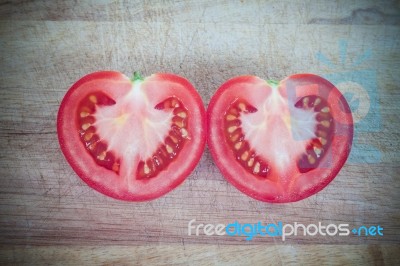 Half Cut Of Red Tomato In Heart Shape Stock Photo