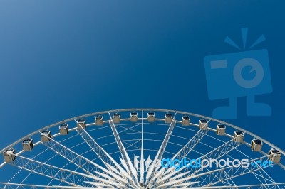 Half Cycle Of White Ferris Wheel Stock Photo