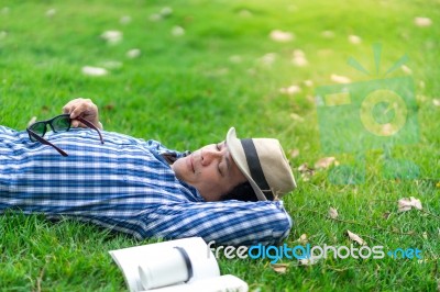 Half Length Man Relaxing And Sleeping In Park Stock Photo