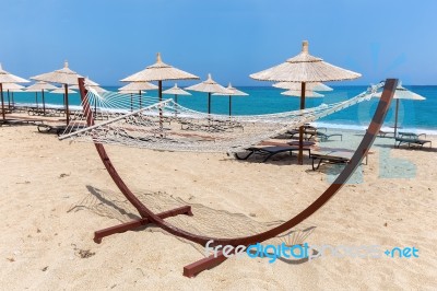 Hammock With Beach Umbrellas At Coast Stock Photo