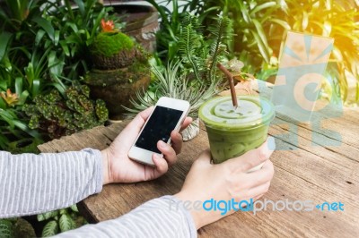 Hand Hold Cool Green Tea And Smartphone Stock Photo