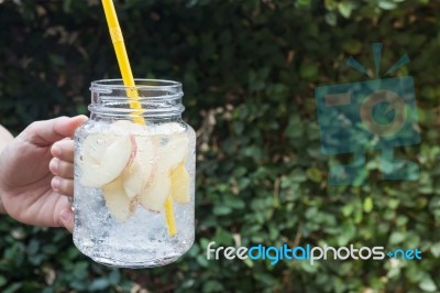 Hand Hold Glass Of Iced Apple Soda Drink Stock Photo