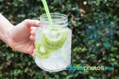 Hand Hold Glass Of Iced Kiwi Soda Drink Stock Photo