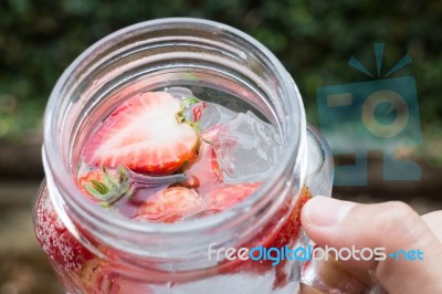 Hand Hold Glass Of Iced Strawberry Soda Drink Stock Photo