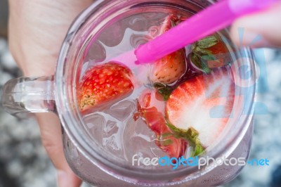 Hand Hold Glass Of Iced Strawberry Soda Drink Stock Photo