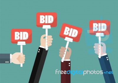 Hand Holding Auction Paddle Stock Image