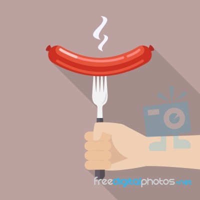 Hand Holding Grilled Sausage On The Fork Stock Image