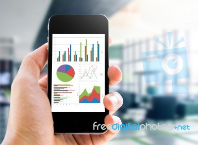 Hand Holding Mobile Phone With Analyzing Graph Stock Photo