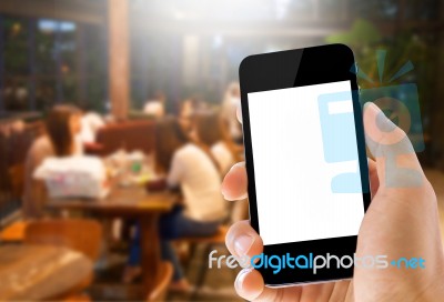 Hand Holding Phone On Coffee Cafe Background Stock Photo