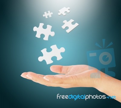 Hand Holding Puzzle Pieces Stock Photo