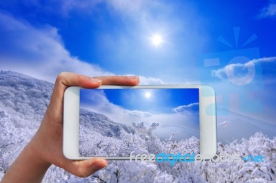 Hand Holding Smart Phone Take A Photo At Deogyusan Mountains In Winter Stock Photo