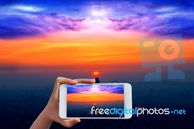 Hand Holding Smart Phone Take A Photo At Sunset And Beautiful Sky At Lotte World Mall In Seoul Stock Photo