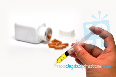 Hand Holding Syringe Stock Photo