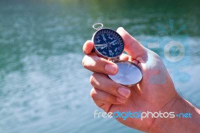 Hand Holding The Black Compass Stock Photo