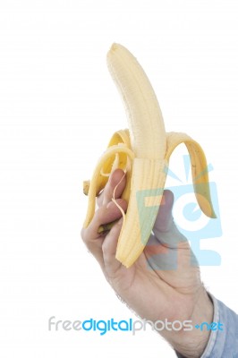 Hand Holding Unbitten Banana Stock Photo