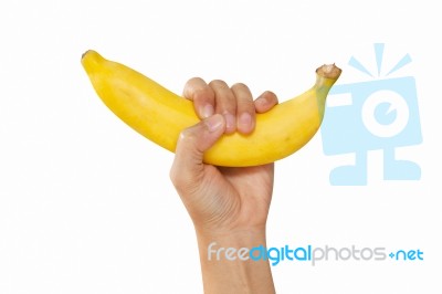 Hand Holds A Banana, Is Isolated On A White Background Stock Photo