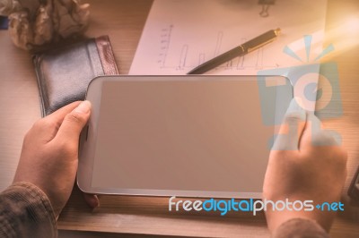 Hand Of Holding Tablet On Desk Stock Photo