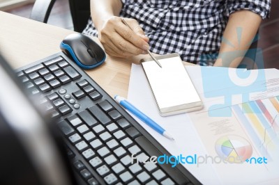 Hand Of Working Woman With Smart Phone Writing Pen On Touching Screen With Copy Space On Office Working Table Stock Photo