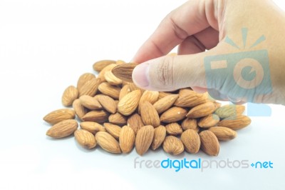 Hand On Almond Grain Isolated On White Background Stock Photo