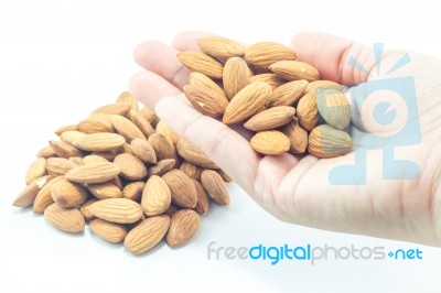 Hand On Almond Grain Isolated On White Background Stock Photo