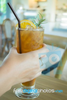 Hand On Iced Lemon Tea Stock Photo