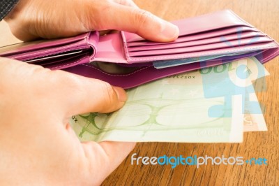 Hand On International Currencies Bank Note In The Wallet Stock Photo