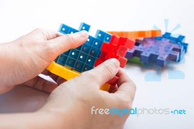 Hand On Jigsaw Puzzle Game Stock Photo