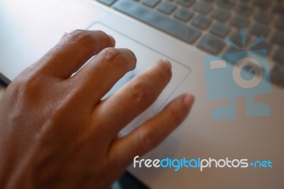 Hand On Laptop Pad Stock Photo