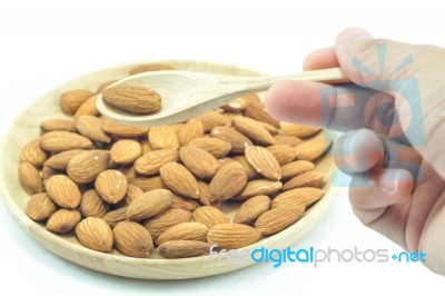 Hand On Spoon Of Almond Isolated On White Background Stock Photo