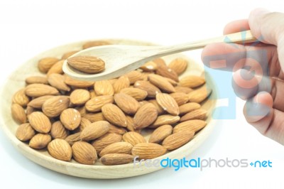 Hand On Spoon Of Almond Isolated On White Background Stock Photo