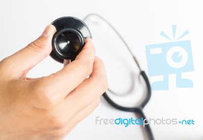 Hand On Stethoscope On White Background Stock Photo