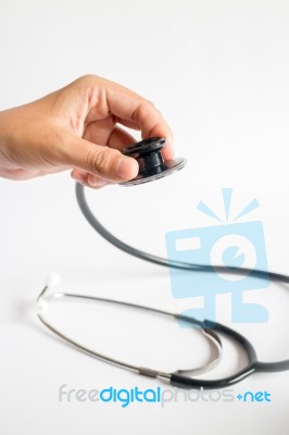 Hand On Stethoscope On White Background Stock Photo